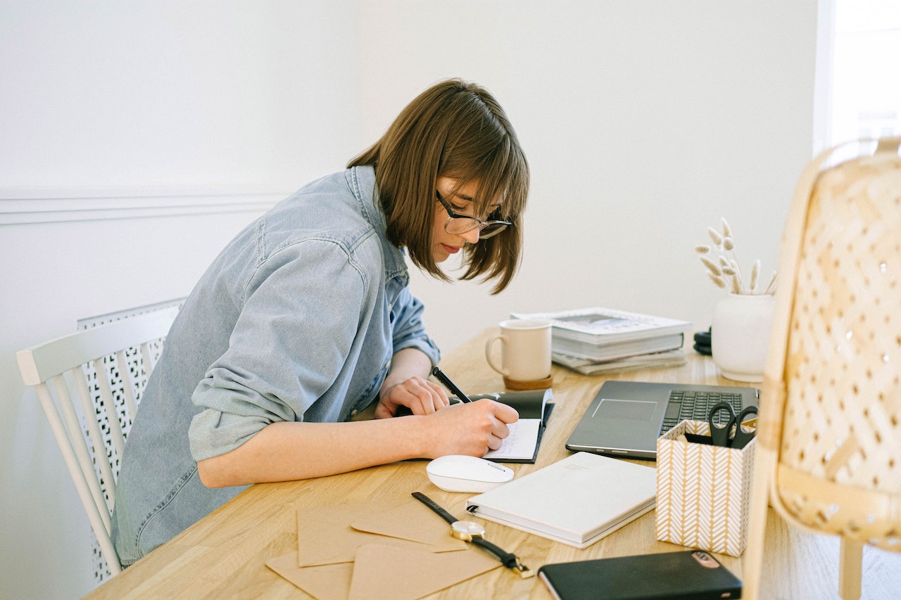 Woman working in home office on table