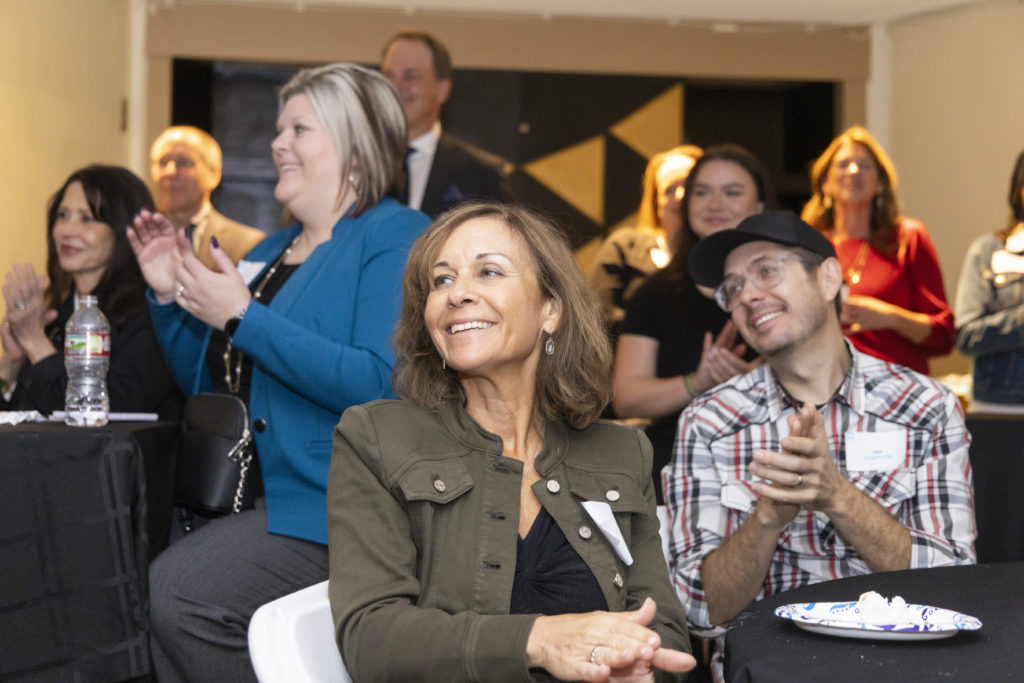 Guests clapping at Risch Results clients and friends event with the Dallas Theater Center